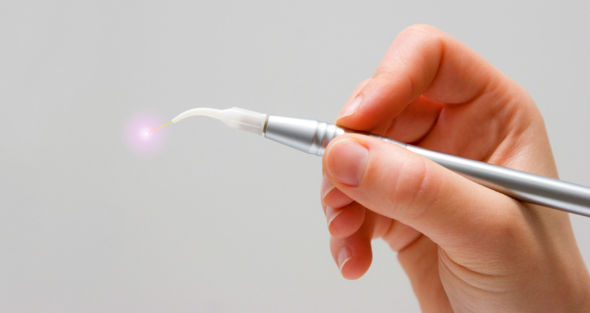 hand holding oral surgery lighted tool