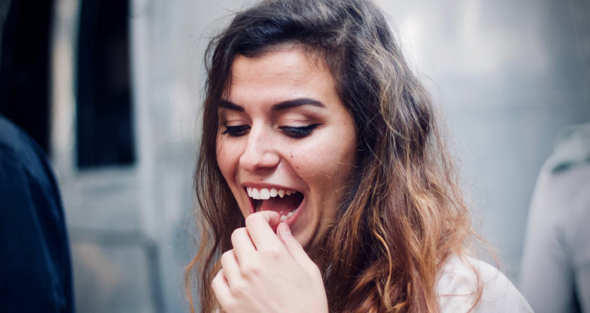 girl holding her tooth