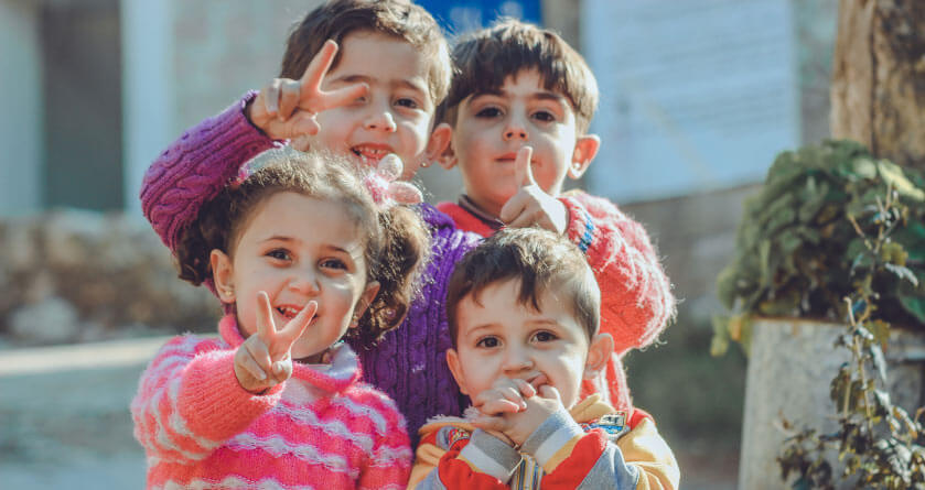 four young kids posing 