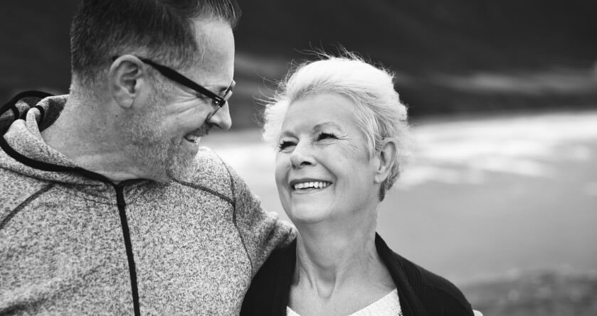 elderly couple smiling at each other