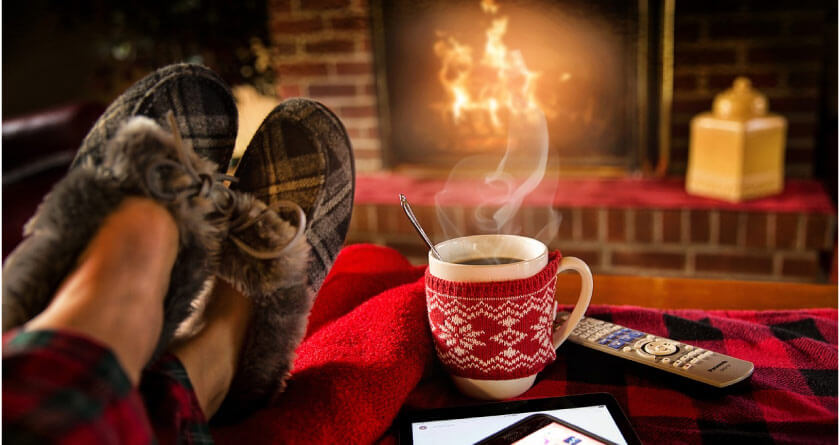 relaxing in slippers with a hot drink in front of the fire after oral surgery