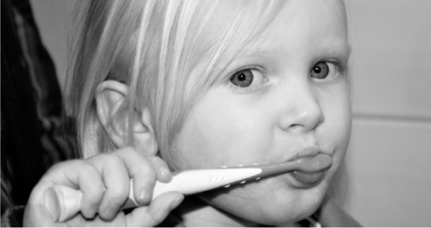 young girl  brushing her teeth