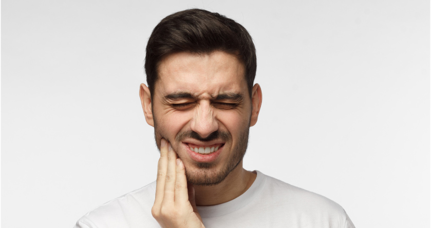 man holding his jaw wondering if he has a dental emergency