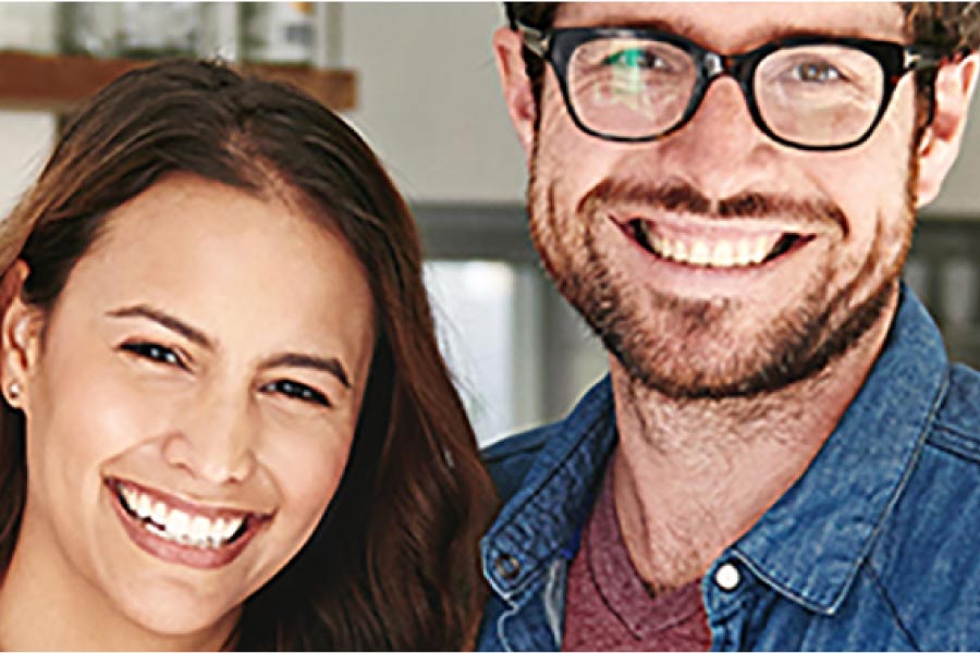 couple smile showing off their porcelain veneers