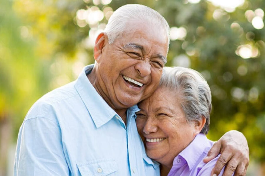 senior couple hug and smile after learning about the versatility 