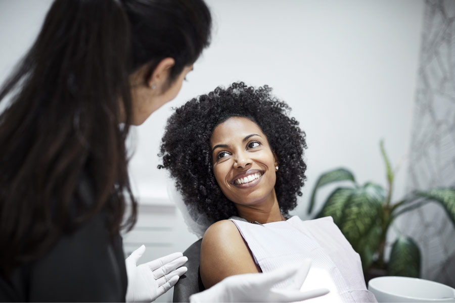 dark haired woman in dental chair waiting for myofunctional therapy