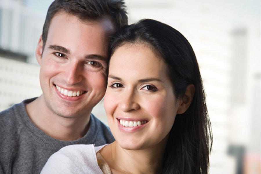 young couple smiles showing off their white straight teeth