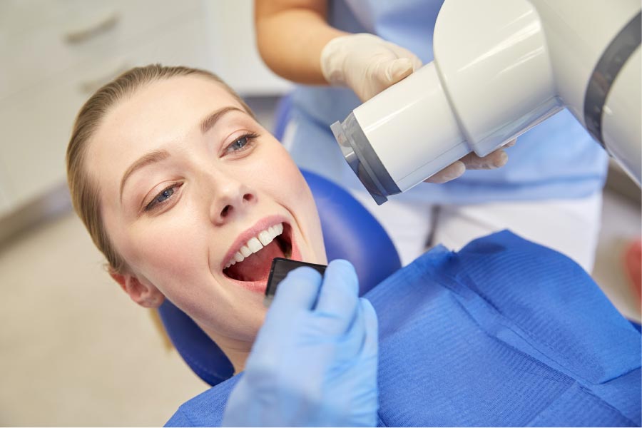 young woman gets digital X-rays at the dentist office